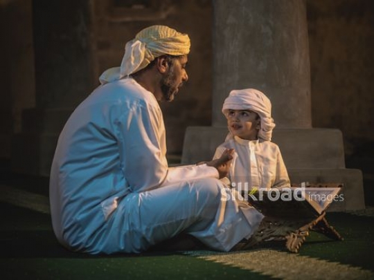 Old man teaching islamic values to grandson|-