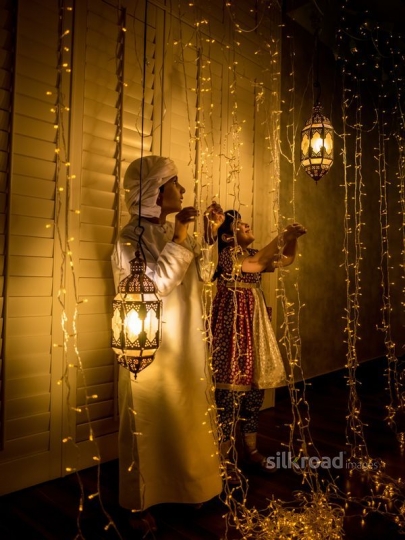 Boy and girl celebrating ramadan ornaments|-