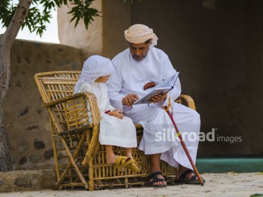 Grandfather educating grandson|-