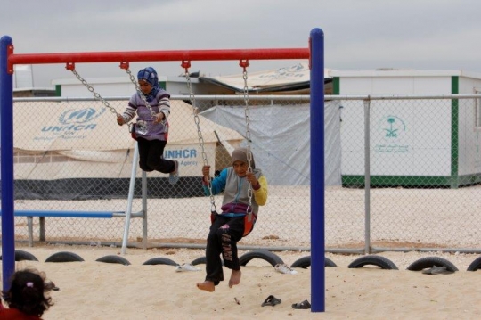 kids play with swing in a refugee camp