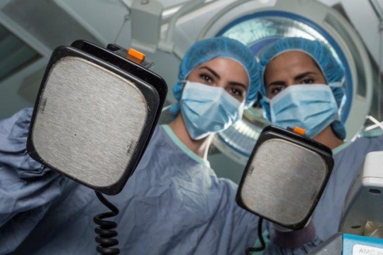 Surgeons Holding Electric Card