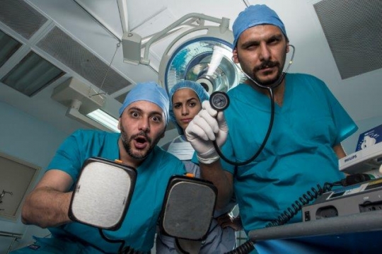 Surgeons Holding Electric Cardioversion and Surgical Tools