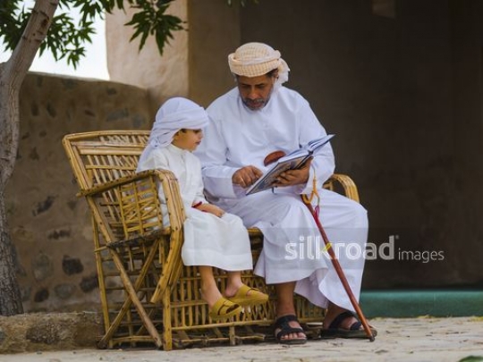Old man educating grandson|-
