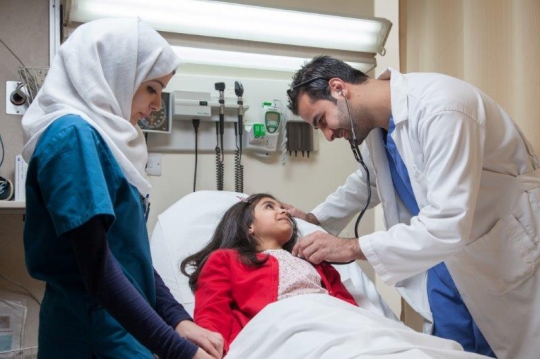 Doctor Examining Little Girl at ER