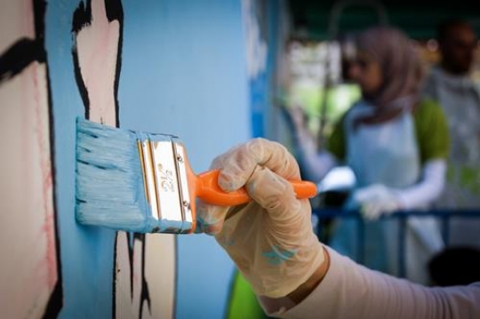 group of volunteer painting the wall of kindergarten