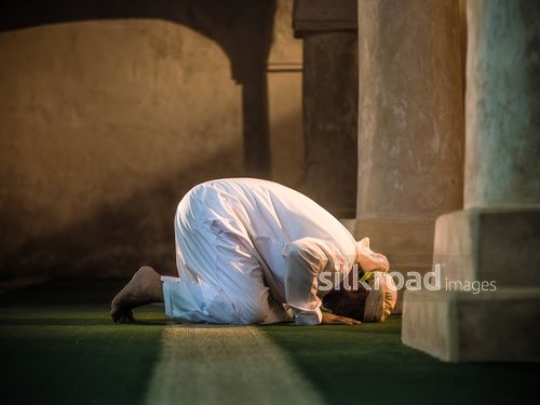 Old man praying on the floor|-