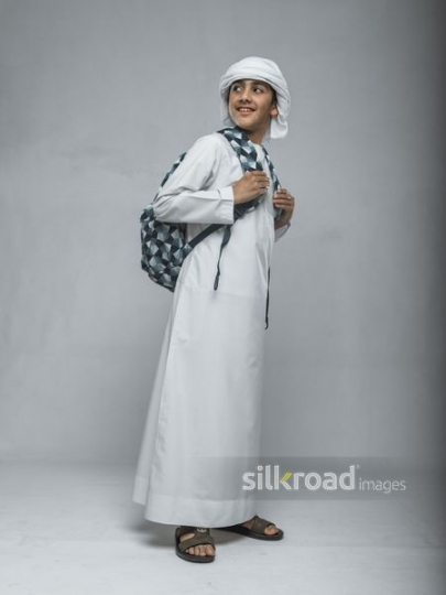 Arabian school boy carrying his school bag