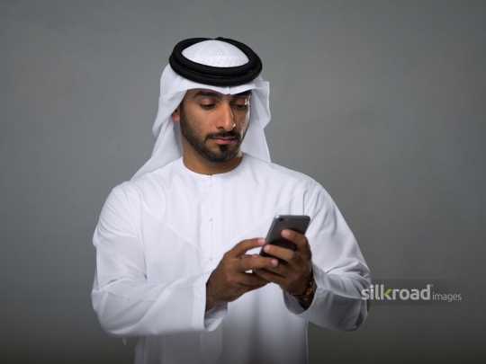 Arab Man messaging from mobile|