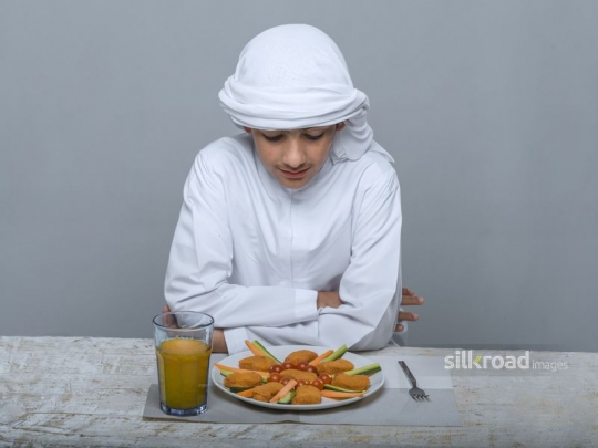 Arabian boy awaiting to be served