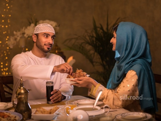 Couple having Arabic sweets|-