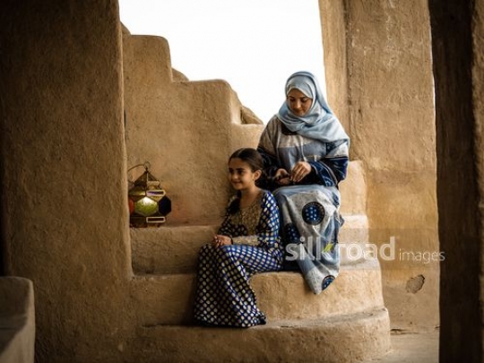 Mother fixing hair for daughter|-