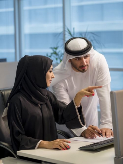 Businessman and business woman at the office working|