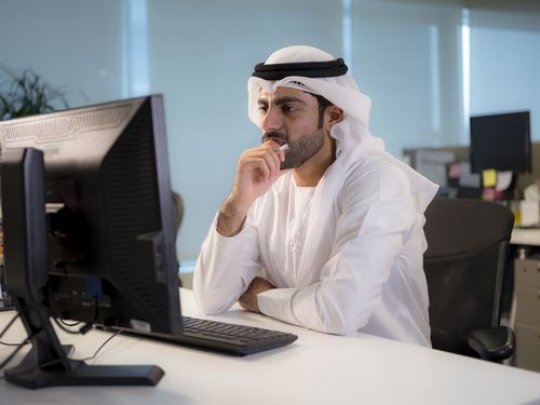 Business man thinking and sitting by his desk|