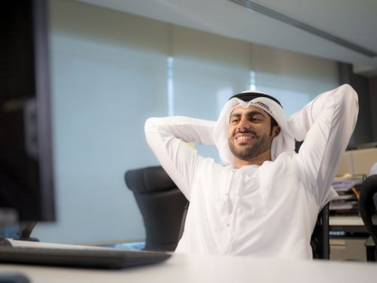 Happy Business man leaning back on his chair|