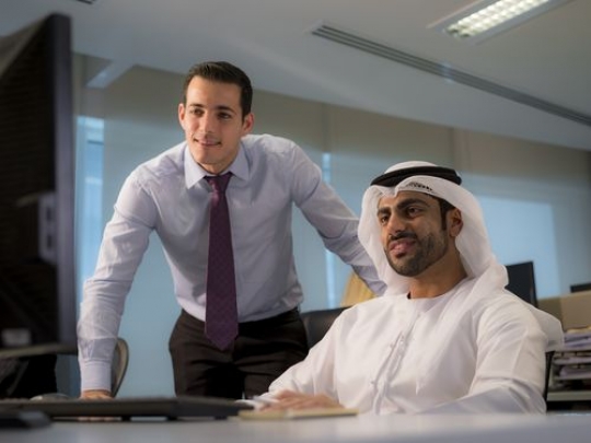 Both business men are looking at the work computer|