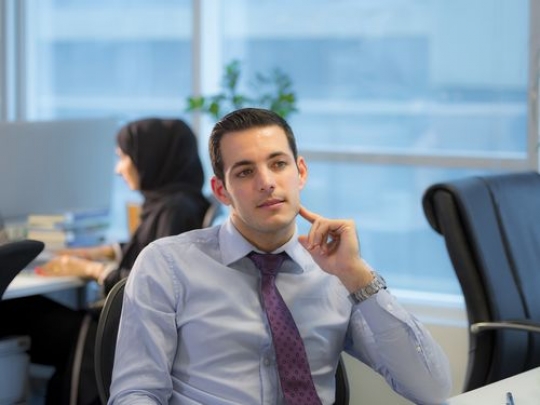 Arab Employee sitting by the desk |-