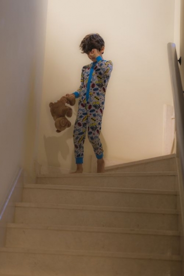 Arab boy walking down the stairs|-