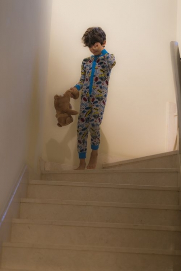 Arab boy walking down the stairs|-