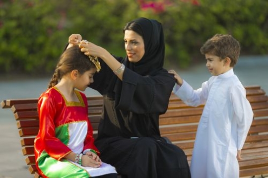 Mother and kids dressed in traditional attire celebrating national day|-
