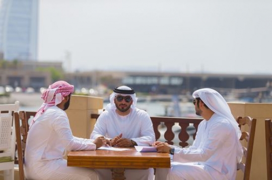 Business men sitting outside during a meeting|
