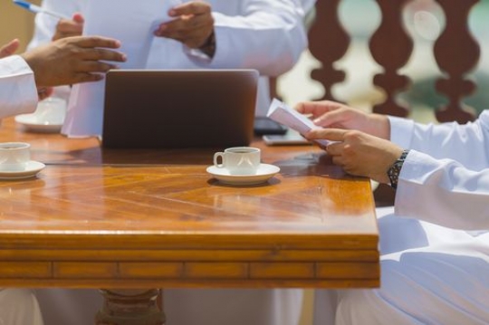 Arab men sitting together during a business meeting|