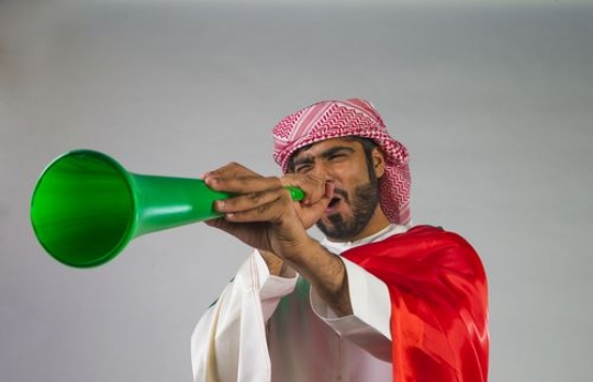 Middle Eastern man celebrating