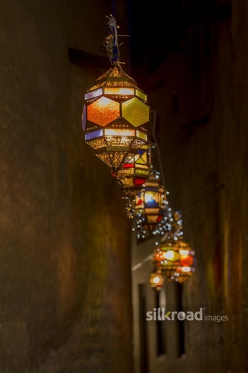 An alleyway decorated by Ramadan Lanterns|-