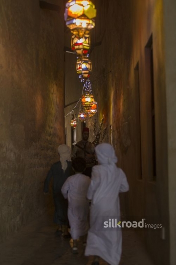 Middle Eastern Ramadan drink seller offering young boys some juice|-