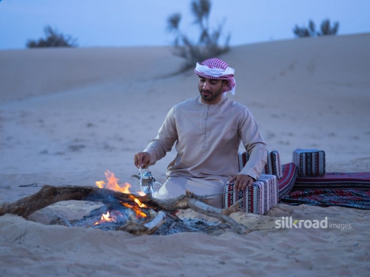 man preparing arabic coffee