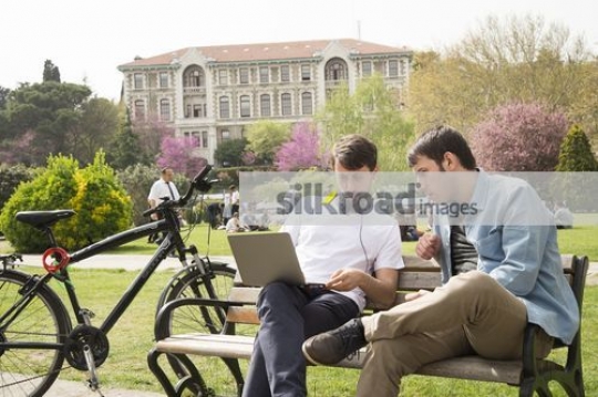 Friends sitting on the bench working