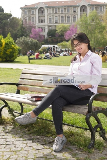 Woman sitting on the bench studying|