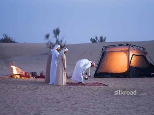 men standing in prayer