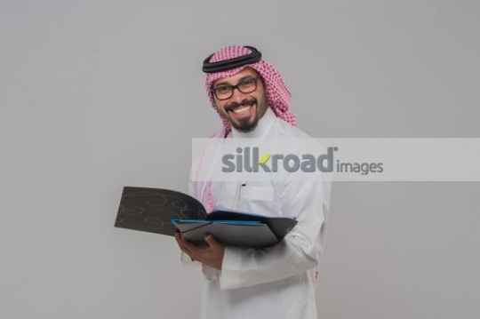 Businessman smiling with folder in his hand|