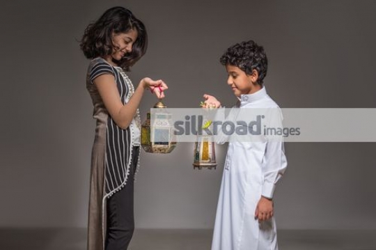 Young Middle Eastern kids carrying the Ramadan Lantern|
