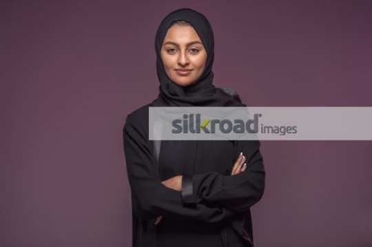 Middle Eastern woman standing arms crossed|