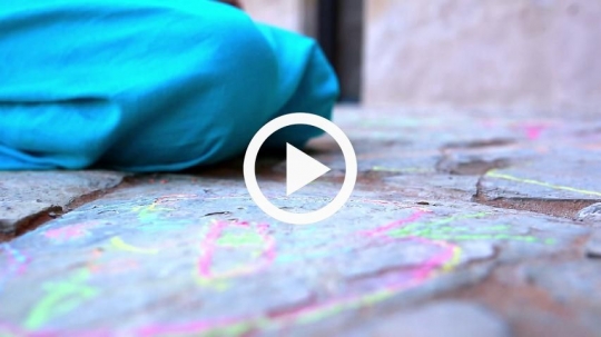 Close-up of girl sketching on the floor