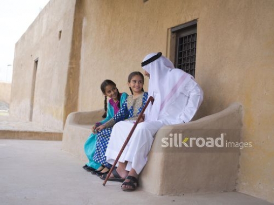 Grandfather sitting with kids|-