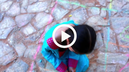 Top view of girl sketching on the floor