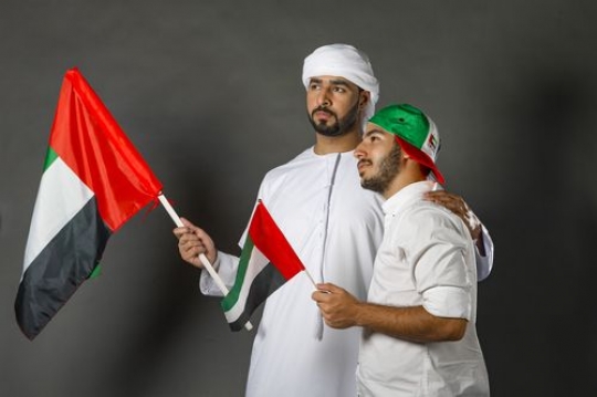Two men proudly celebrating UAE