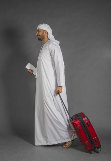 Arab Businessman walking with carry on|-