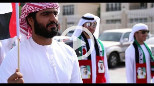 A group of arabs celebrating the UAE National Day during a parade|