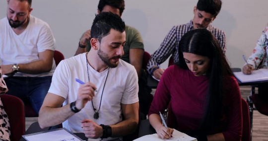Middle Eastern Students talking to each other in class|-
