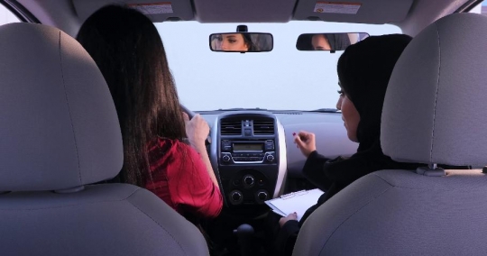 Driving instructor teaching the students the basics of driving |-
