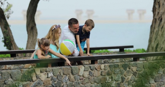 Western couple with the kids at the bridge|-