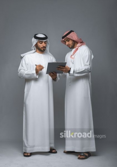 Middle Eastern manager signing the papers |