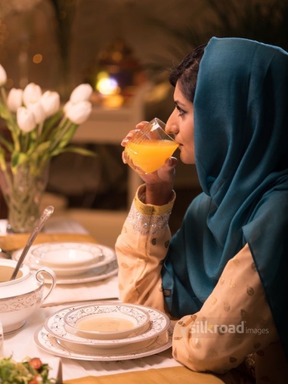 Woman drinking orange uice|-