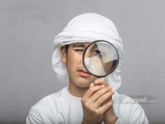 Boy looking through magnifier
