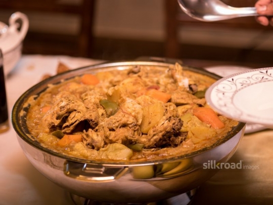 Serving traditional meal|-