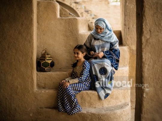 Mother making braids for girl|-