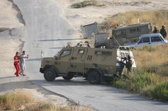 Israeli soldier stopping Palestinians 